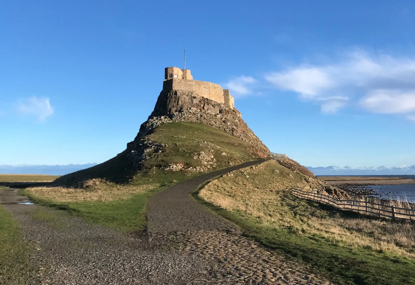 Lindisfarne Castle on its rocky outcrop above the shoreline