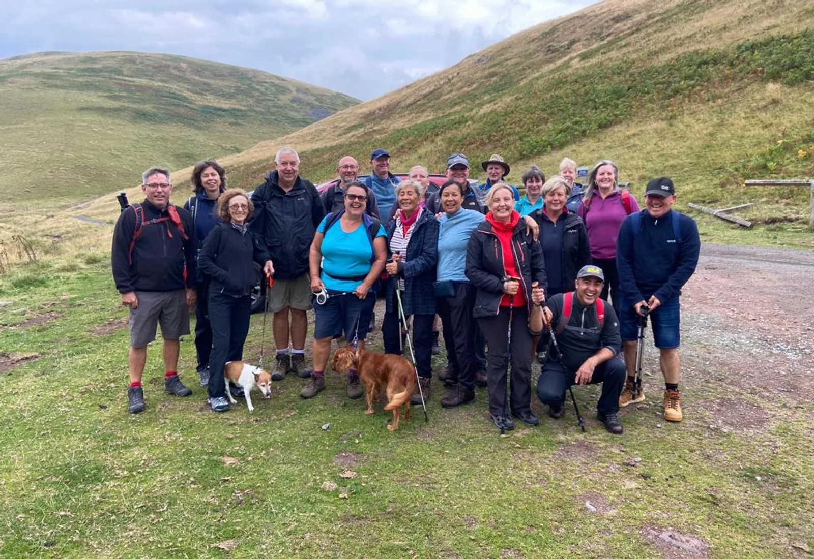 A walking group gathered on the hillside below Yeavering Bell